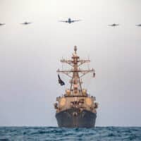 THE GUIDED-MISSILE DESTROYER USS MCFAUL (DDG 74) CONDUCTS A PHOTO EXERCISE WITH A U.S. NAVY P-8 POSEIDON AND FOUR U.S. AIR FORCE A-10 THUNDERBOLT II’S IN THE ARABIAN GULF, AUG. 4, 2023. (PHOTO: MASS COMMUNICATION SPECIALIST 2ND CLASS JUEL FOSTER VIA WWW.NAVY.MIL)