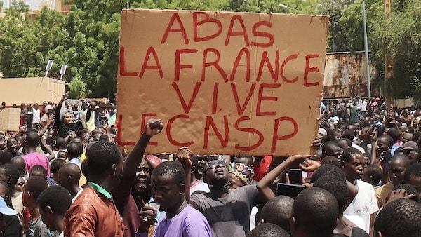 | Protesters with sign that reads Down with France long live the CNSP National Council for the Safeguard of the Homeland | MR Online