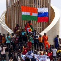 Protesters display the flags of Niger and Russia during a protest in Niamey, Niger. Photo by Efe Issifou/Flickr.