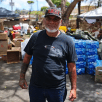 Keʻeaumoku Kapu — a Kanaka Maoli community leader and head of the Nā ʻAikāne o Maui Cultural Center — handing out supplies in a Lahaina Walgreens parking lot. The cultural center was destroyed in the fires.