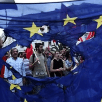 e: People protesting in Greece with a torn Europe Union flag during protests against neoliberal austerity measures in 2015. Photo: AP/File photo.