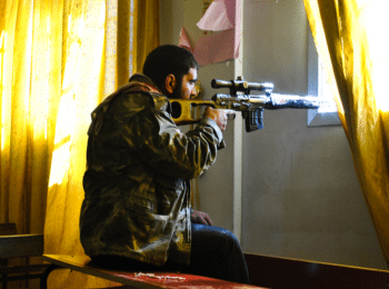 | A Syrian anti government fighter aims a sniper rifle inside a classroom at a school in Homs Syria Feb 22 2012 Photo | AP | MR Online