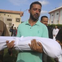 | A relative carries the body of Amir Ganan who was killed by an Israeli air strike during his funeral in Khan Younis Gaza Strip October 10 2023 | MR Online