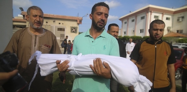 | A relative carries the body of Amir Ganan who was killed by an Israeli air strike during his funeral in Khan Younis Gaza Strip October 10 2023 | MR Online