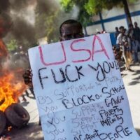 Haitian protester holds an anti-US sign during a protest against the unelected, US-backed Haitian regime, in Port-au-Prince, Haiti, on Oct. 17, 2022. Photo: Richard Pierrin/AFP.