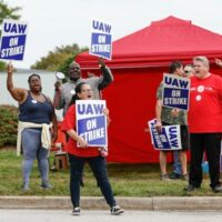 UAW members and workers at the Mopar Parts Center Line in Center Line, Michigan, hold signs outside the facility after walking off their jobs at noon on September 22, 2023. (PHOTO BY KAMIL KRZACZYNSKI / AFP)