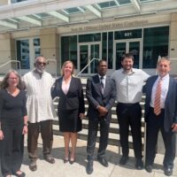 Members of the Uhuru 3 and their defense lawyers outside the Sam Gibbons US courthouse in Tampa, Florida