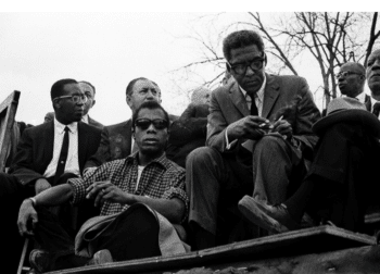 | Author James Baldwin civil rights leader Bayard Rustin and labor unionist A Philip Randolph front row left to right wait at the speakers | MR Online' platform at the Selma to Montgomery March on March 25, 1965. PHOTO BY STEPHEN F. SOMERSTEIN/GETTY IMAGES