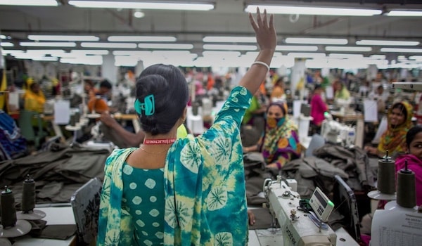 | Pushpa Rani Shaha gives a victory wave to fellow garment workers Source ILO Asia Pacific Flickr cropped from original shared under license CC BY NC ND 20 | MR Online