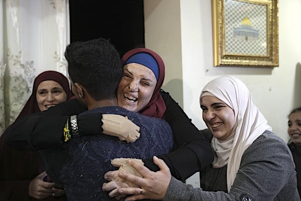 | Israa Jaabis center a Palestinian prisoner released by Israel is hugged by relatives as she arrived home in East Jerusalem Nov 26 2023 | MR Online