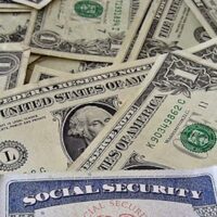 A social security card on a bed of money