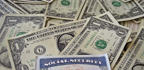 | A social security card on a bed of money | MR Online