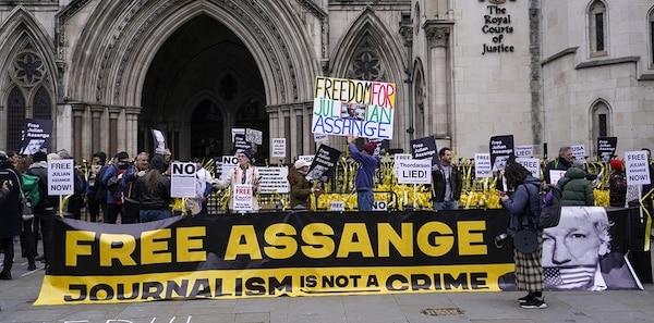 MR Online | Demonstrators hold banners outside the Royal Courts of Justice in London February 20 2024 | MR Online