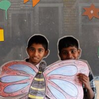 Students display a butterfly they made at the Madu Adu (science, or ‘let’s do it’) corner. Credit: Photographs and collages by Tricontinental: Institute for Social Research.