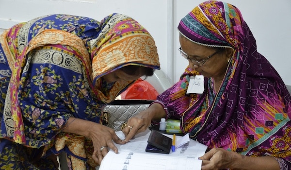 MR Online | A polling official confirms a voters identity during the Pakistani general elections in July 2018 Photo Commonwealth Secretariat on Flickr | MR Online