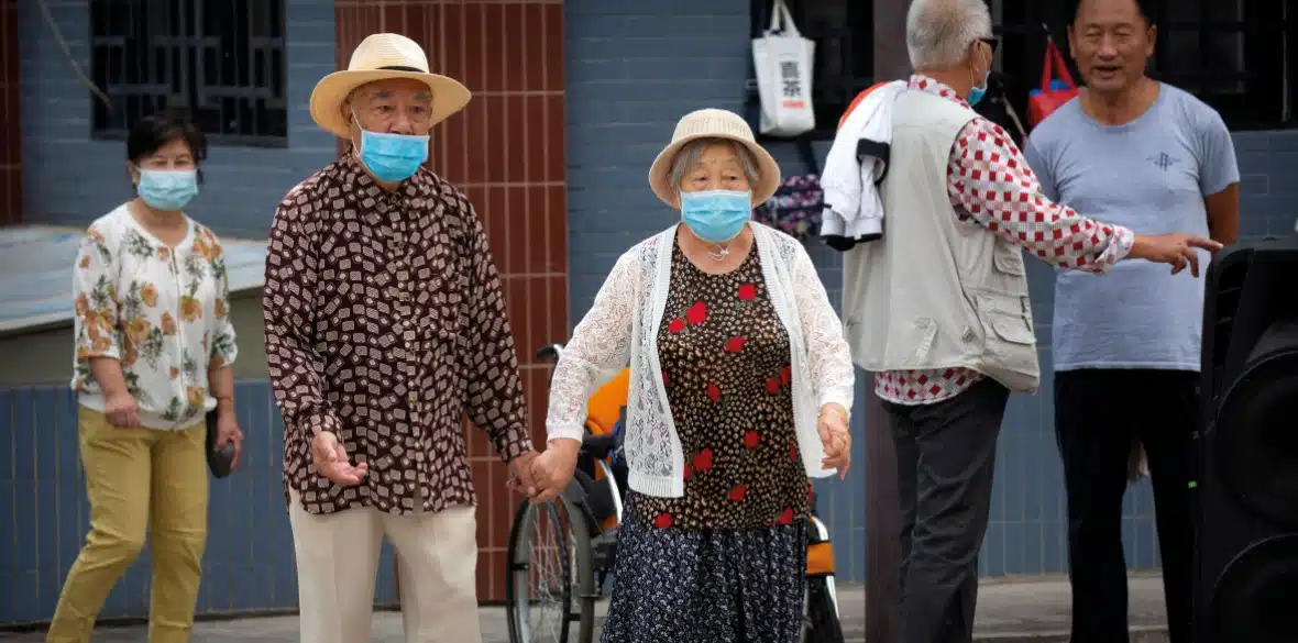 MR Online Part 6 | COVID V CHINA An elderly couple wearing face masks to protect against the coronavirus walk in a park in Beijing 2020 | MR Online