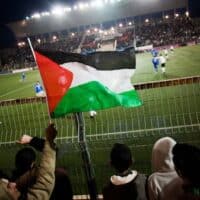 Palestinian soccer supporters watch a match between the Palestinian team and Thailand in the West Bank town of Al-Ram, near Ramallah. Bernat Armangue | AP