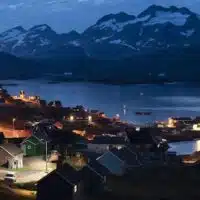 Homes are illuminated after the sunset in Tasiilaq, Greenland, August 16, 2019