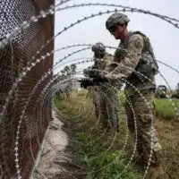 Soldiers put concertina wire on a border fence near the Brownsville and Matamoros Express International Bridge in Brownsville, Texas.