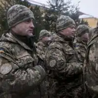 Ukrainian soldiers of the 1st Battalion, 28th Mechanized Infantry Brigade sing along as their national anthem is played during the opening ceremonies for their training rotation with the Joint Multinational Training Group - Ukraine at the International Peacekeeping and Security Center, near Yavoriv, Ukraine, on Feb. 2. (Photo by Sgt. Anthony Jones, 45th Infantry Brigade Combat Team)