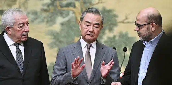 MR Online Part 3 | Chinas Foreign Minister Wang Yi centre hosts an event for Mahmoud al Aloul left vice chairman of Fatah and Mussa Abu Marzuk a senior member of Hamas to meet at the Diaoyutai State Guesthouse in Beijing July 23 2024 | MR Online