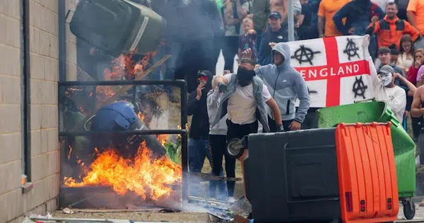 | Protestors throw a blazing garbage bin outside the Holiday Inn Express in Rotherham on SundayStringerReuters | MR Online