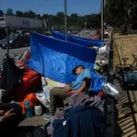 A group of unhoused people camp outside the Housing Matters shelter in Santa Cruz on Aug. 7, 2024.