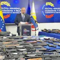 Venezuelan Interior Minister Diosdado Cabello addresses the media in front of some of the 400 seized firearms linked to an alleged assassination plot. (MPPRIJP)