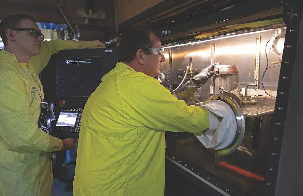 | Two workers at the Los Alamos National Laboratory using a glove box the equipment that allows them to handle toxic or volatile substances inside a sealed chamber | MR Online