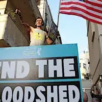 A protester waves the US flag during a gathering calling for the release of Israeli hostages in Gaza, in Tel Aviv on 19 August 2024 (Jack Guez/AFP)