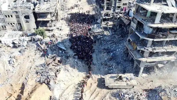 | A PHOTO CIRCULATING ON SOCIAL MEDIA SHOWS ISRAELI SOLDIERS FORCING DISPLACED PEOPLE IN JABALIA CAMP TO MOVE TOWARD A CHECKPOINT TARGETING THOSE WHO DONT MOVE WITH DRONE AND ARTILLERY FIRE PHOTO SOCIAL MEDIA | MR Online