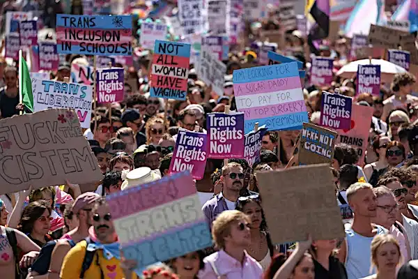 MR Online | Demonstrators hold placards during a London Trans Pride protest Photo by Hollie AdamsGetty Images | MR Online