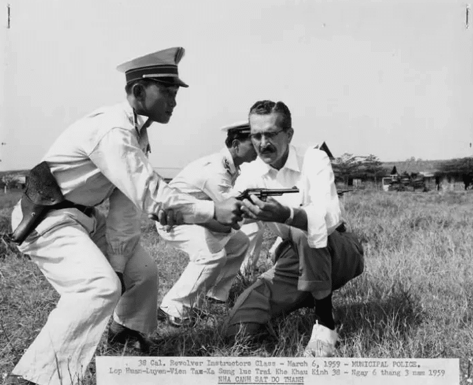 | An Michigan State University Group adviser instructor helps a Vietnamese municipal police officer on his technique with a 38 caliber revolver March 6 1959 Source politicocom | MR Online