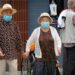 COVID V CHINA: An elderly couple wearing face masks to protect against the coronavirus walk in a park in Beijing, 2020
