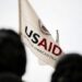 An Agency for International Development flag flies in front of USAID headquarters in Washington, D.C. Graeme Sloan | Sipa via AP