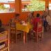 Residents of Quisicuaba eat together in the dining area. Credit: Benjamin Zinevich