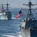 US warships off the China coast. China’s socialist economy is seen as a threat to US capitalism so tariffs and war maneuvers are used to threaten the People’s Republic.